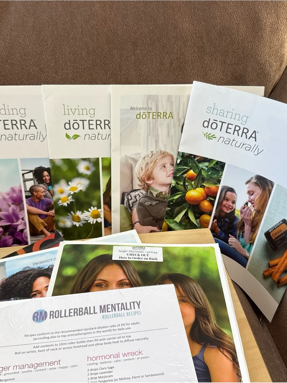 DōTerra essential oil box with 13 new/opened exp oils with extra bottles/info.